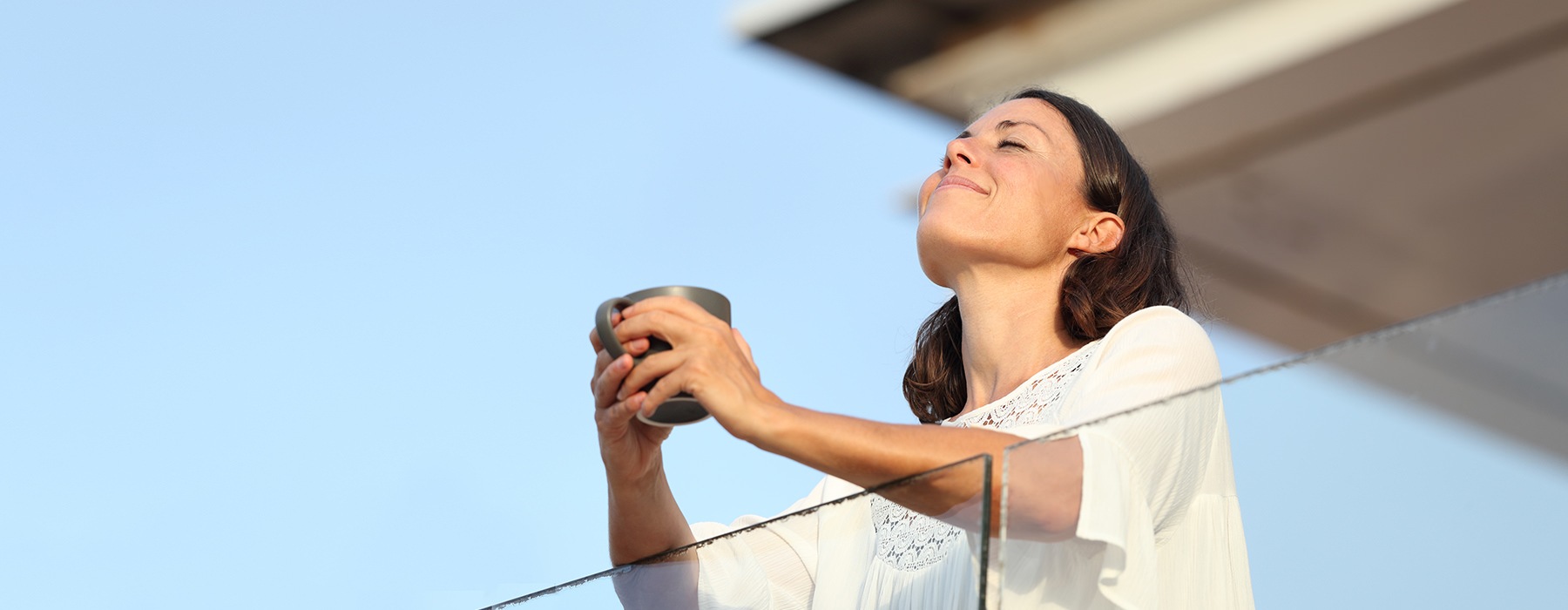 Woman standing on her balcony 